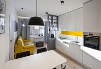 Kuchyně navržená na míru působí díky použitým barvám a materiálům jednoduše a dokonale splývá s obývací částí bytu.