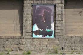 Zničený plakát s portrétem Františka Mrázka.