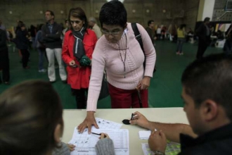 Voliči při otisku prstů v Bogotě.
