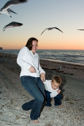 Žena s dítětem krmící racky na Floridě.