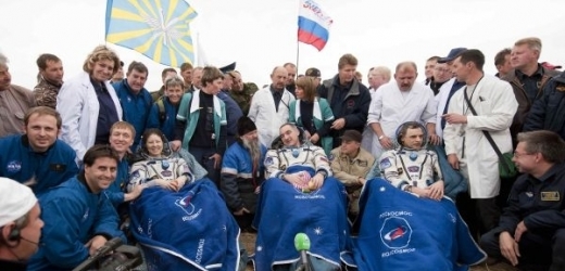 Posádka Sojuzu po dosednutí v kazašské stepi.