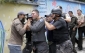 Policejní vzbouřenci před nemocnicí 'zpracovávají' příslušníka prezidentské gardy.