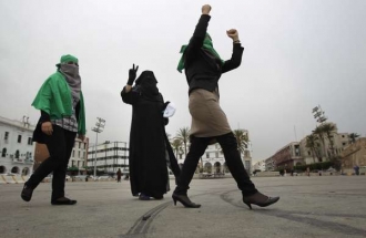 Skupinka žen tancuje v Tripolisu radostí z vítězství vládních vojsk.
