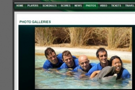 Tomáš Berdych v bazénu s dalšími tenisty a delfínem.