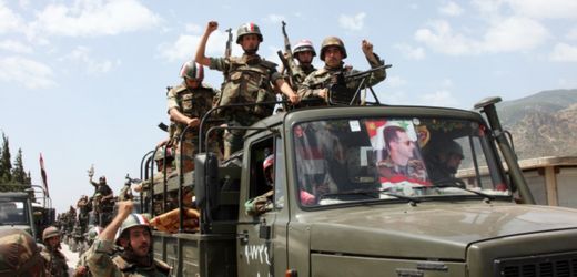 Vládní síly s portrétem prezidenta Asada na čelním skle.
