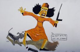 Teď už se smí... Karikatura Kaddáfího, jehož kouše nečisté zvíře, na stěně kdesi v Tripolisu.  