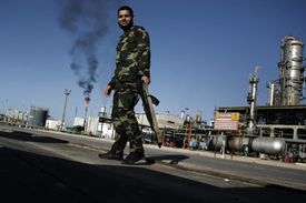 Rebelové hlídají jednu z rafinerií v Libyi. Kaddáfí z příjmů z ropy bohatě obdarovával své krajany.