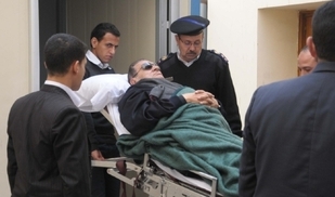 Mubaraka k soudu přinesli na nosítkách, protože je nemocen.