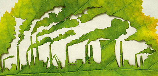 Kouřící továrny vyřezané do zeleného listu.