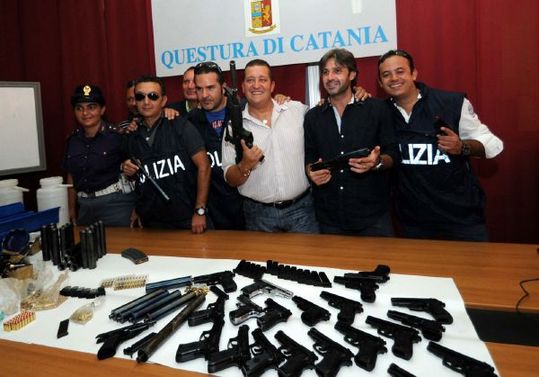 Policisté se zbraněmi vyrobenými zbrojířem Cosa Nostry Giuseppem Scadutem.