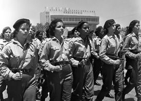 Ozbrojené kubánské policistky pochodují v Havaně roku 1962.