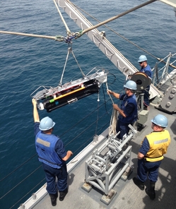 Posádka USS Avenger spouští do vody miniponorku SeaFox. 