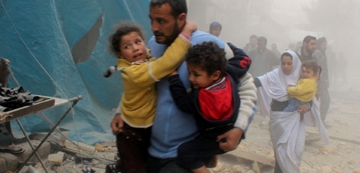 Otec s dětmi utíká před bombardováním v Aleppu.