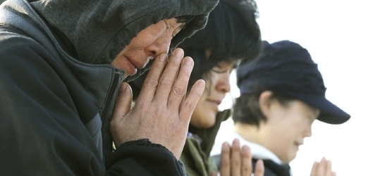 Příbuzní pohřešovaných cestujících se modlí za jejich záchranu.
