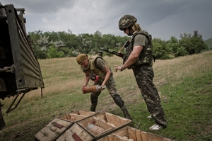 Ukrajinští vojáci vykládají munici na ostřelování bašt rebelů.