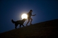 Dívka z Madridu si v měsíčním svitu hraje se psem. (Foto: ČTK/AP)