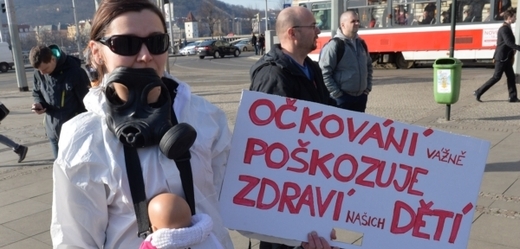 Demonstrantka s transparentem a figurínou dítěte.