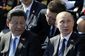 Vladimir Putin sedící při ceremonii vedle čínského prezidenta Si Ťin-pchinga.