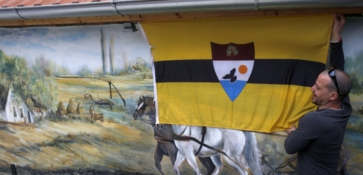 Upevňování vlajky Liberlandu.