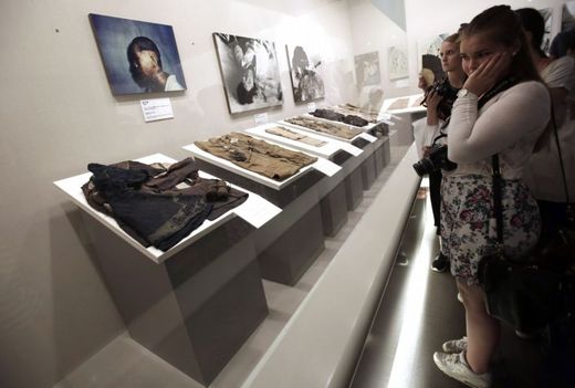 Studenti ze Švédska si v Mírovém pamětním muzeu v Hirošimě prohlížejí fotografie obětí útoku a poničené předměty, které věnovaly většinou rodiny obětí.