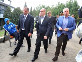 Premiér Bohuslav Sobotka (uprostřed) a ministr vnitra Milan Chovanec (vpravo) navštívili přijímací tábor pro zajištění cizinců v Zastávce u Brna.