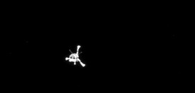 Philae sestupující ke kometě.
