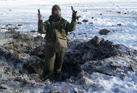 Ukrajinský voják ukazuje šrapnely po výbuchu nedaleko Doněcka (ilustrační foto).