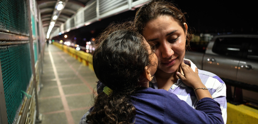 Matka s dítětem na hranici mezi Mexikem a USA.