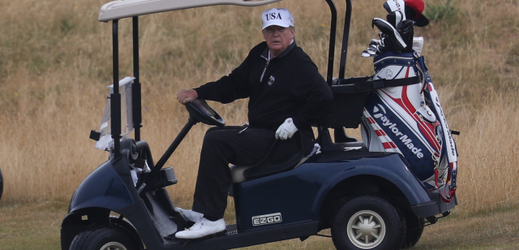 Americký prezident Donald Trump v golfovém vozidle. 