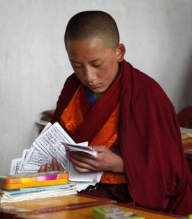 Tradice versus moderna. Tibetský mnich v klášterní škole u Tongrenu.