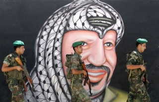 Vojáci Fatahu před obrazem Arafata.