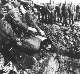 Vojáci Wehrmachtu při popravě partizána.