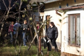 Policisté v civilu prohledávají domek v Hajanech.