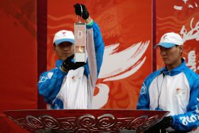 Příslušníci pekingského olympijského komitétu vyvolávají otázky.