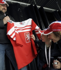Mladí hokejisté si prohlížejí český historický dres.