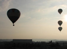 Piloti jednotlivých balónů během letu vytvářejí různé formace.