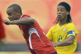 Vincent Kompany (v červeném) v souboji s Brazilcem Ronaldinhem.