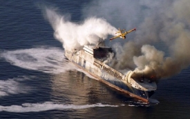 Požár nákladní lodi může způsobit ekologickou katastrofu.