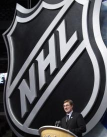 Wayne Gretzky před impozantním logem NHL.