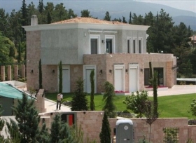 Jedna z Milonasových nemovitostí, vila v Soluni. Na pozemku policista.